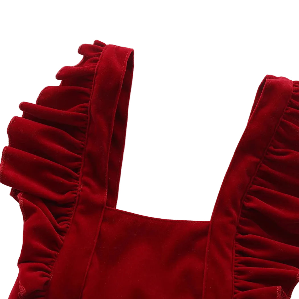 Close-up detail of the square neckline and plush ruffle shoulder straps on the red velvet-style baby jumpsuit.