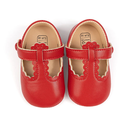 Pair of red infant girl T-strap soft sole shoes viewed from the top down.