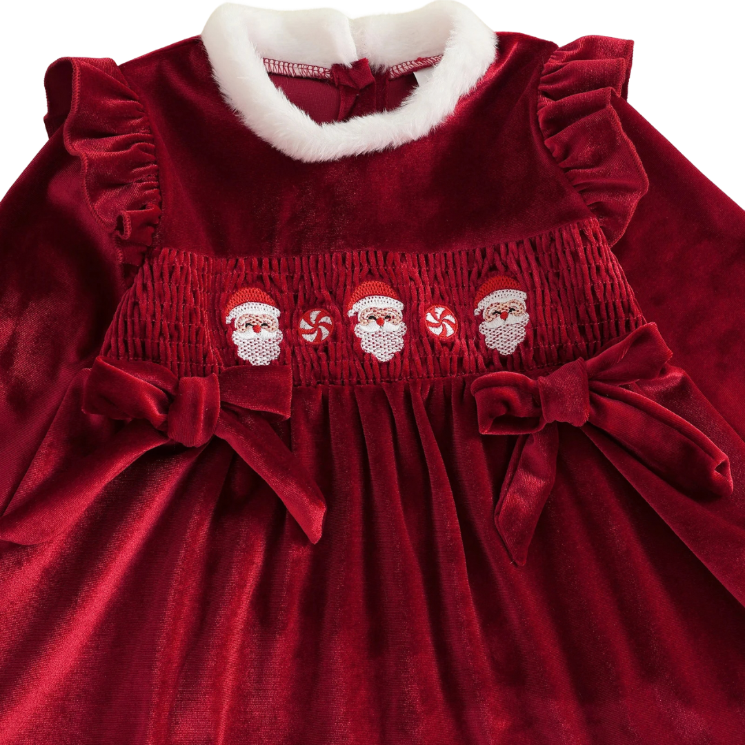 Close-up of embroidered Santa Claus design and side bow accents on Kidsely red velvet dress
