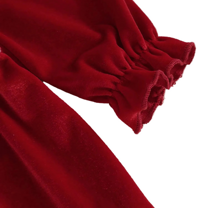 Close-up showing the gently ruffled elastic wrist cuff on the long sleeve of the red dress.