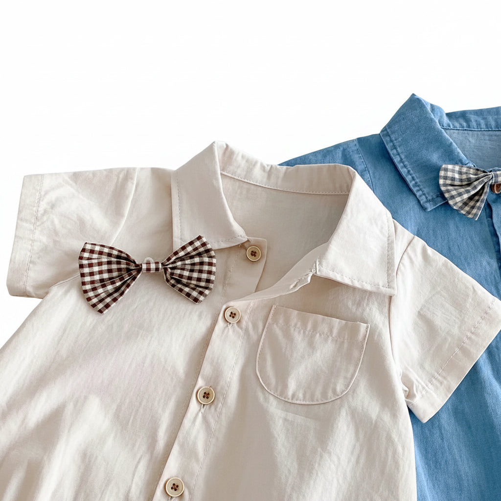 Close-up shot showing the removable gingham bow tie and lapel collar of the baby boy romper.