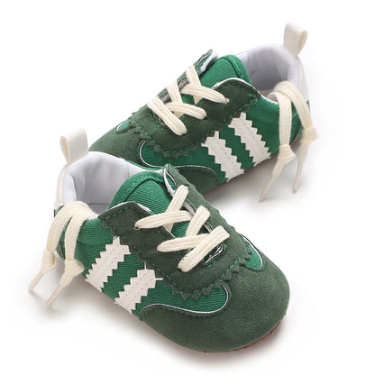 Infant retro-style canvas sneakers in forest green with white serrated stripes and non-slip gum sole.