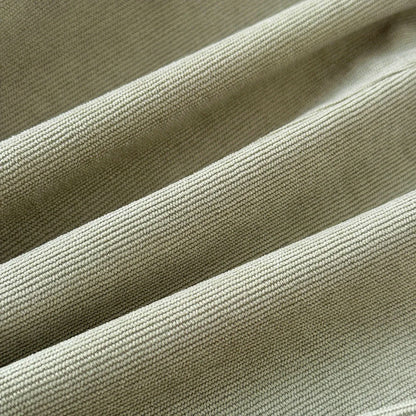 Detailed close-up showing the soft rib-woven sage green corduroy fabric material.