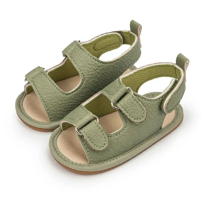 Sage green soft-touch synthetic leather infant sandals with a flat heel design for comfortable first steps.