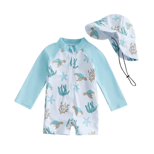 One-piece baby boy long sleeve rash guard swimsuit in white and aqua featuring a sea turtle and starfish print, paired with a matching wide-brim sun hat.