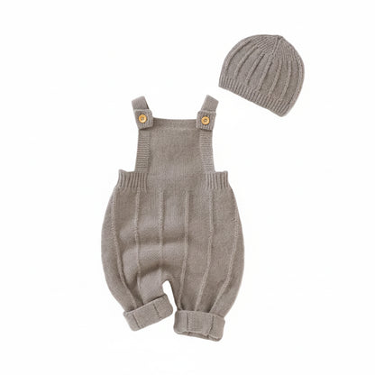 Beige seamless knit overalls and matching ribbed hat set displayed on a clean white background.