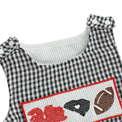Close-up view of the comfortable rounded white inner-lined neckline and functional white button closures on the shoulder straps of the infant seersucker bubble romper.