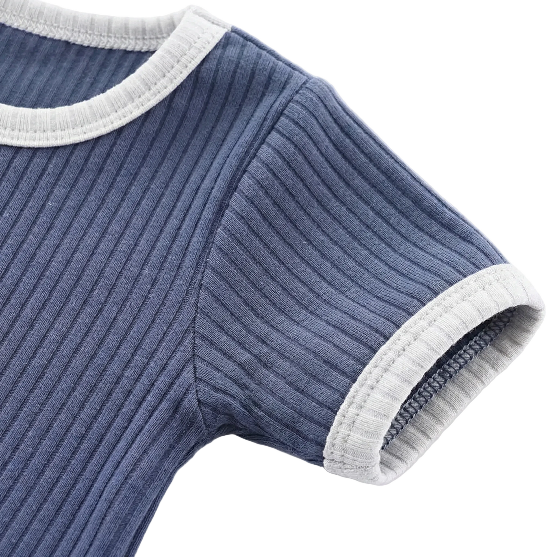 Kidsely durability detail: Close-up of the short sleeve cuff showing reinforced overlock stitching and soft contrast binding.