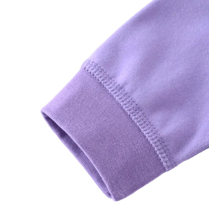 Close-up showing the stitching and ribbed cuff detail on the long sleeve of the purple newborn romper.