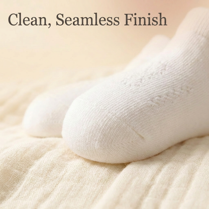 Close up of the clean, seamless toe finish on a white baby sock designed to prevent snagging and toe irritation.