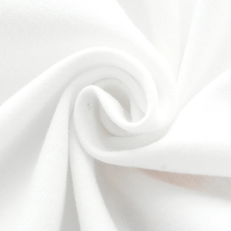 Close up texture shot of the soft, breathable white cotton fabric used for the baby romper.