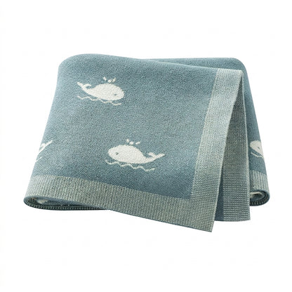 Kidsely soft knit baby blanket in teal with white whale pattern for ocean theme nursery