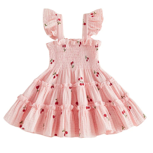 Kidsely Baby and Toddler Girl Smocked Cherry Summer Dress in Soft Rose pink with red cherry pattern and A-line tiered design.
