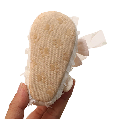 Close-up of Kidsely soft cotton sole with non-slip paw print traction pattern for first walkers.