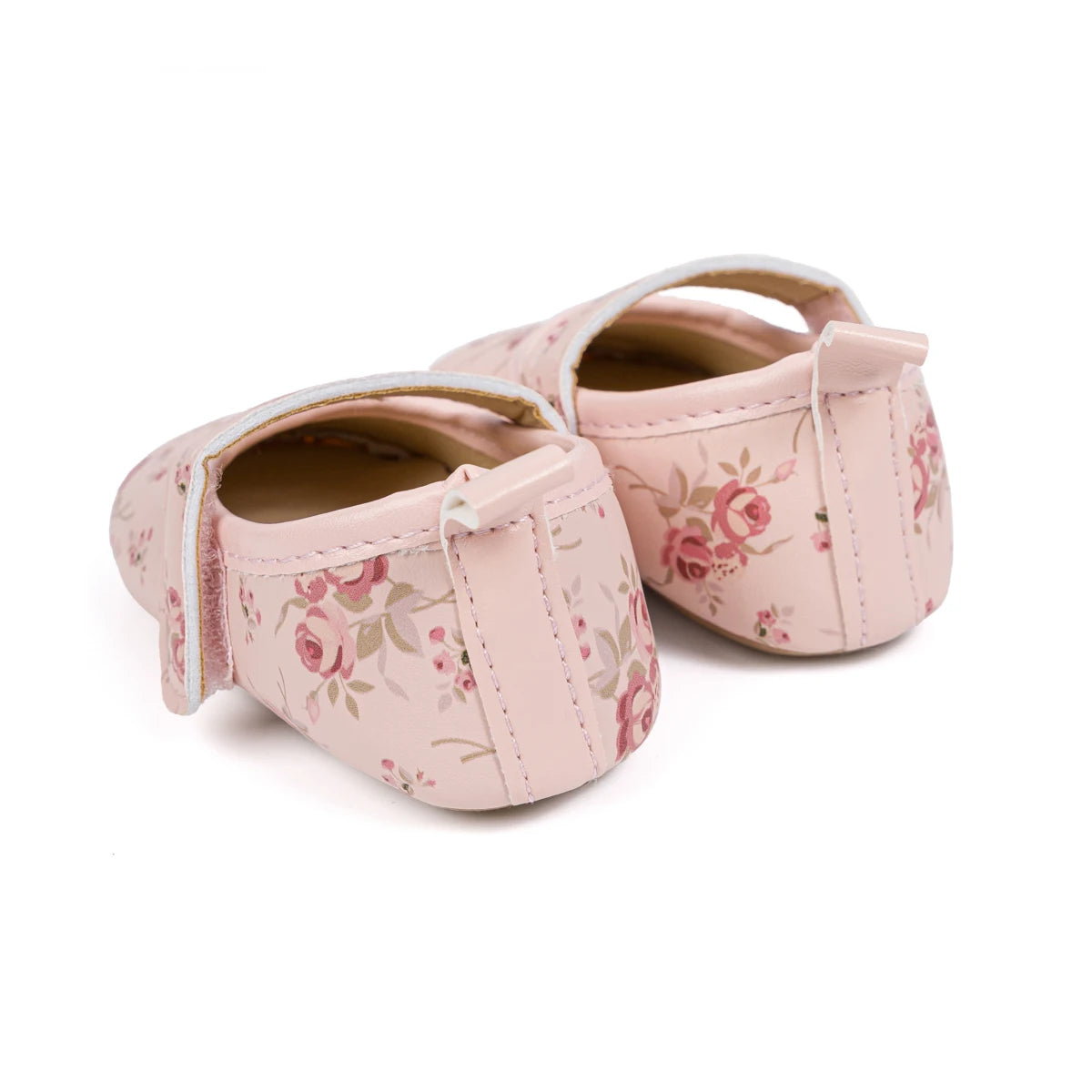 Rear angle view of pink soft sole baby shoes showcasing the neat stitching and vintage rose design.