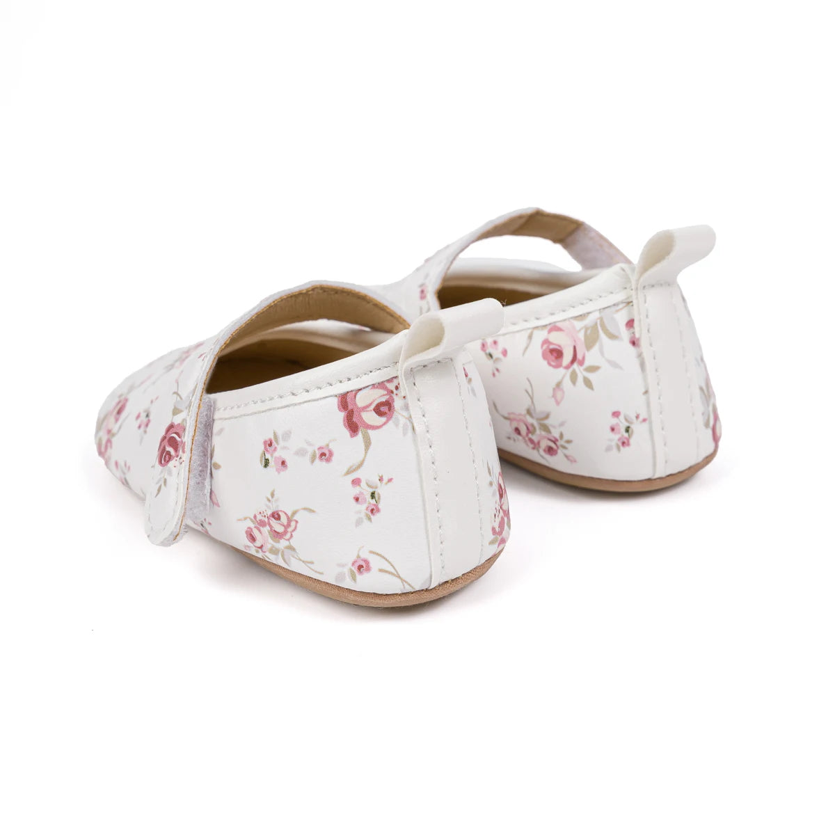 Heel and back view of white soft sole baby shoes featuring a pull tab and rose pattern.