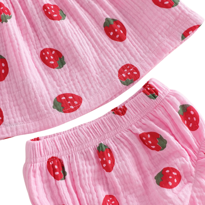 Close-up detail of the breathable 95% cotton crinkle gauze fabric and red strawberry berry print on pink and cream material.