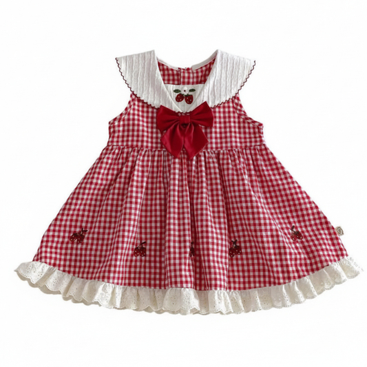 Baby girl red and white gingham check dress featuring strawberry embroidery and a white sailor collar with red scalloped trim; vintage cottagecore style perfect for a Berry First Birthday party or a summer cake smash outfit.