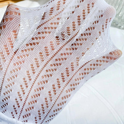 hand stretching white chevron pointelle tights fabric showing breathability