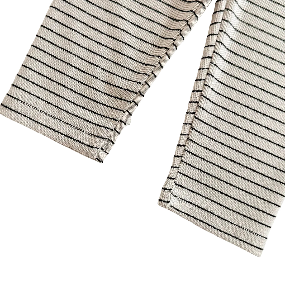 A close-up showing the bottom ankle hems and stripe pattern of the ribbed baby leggings.