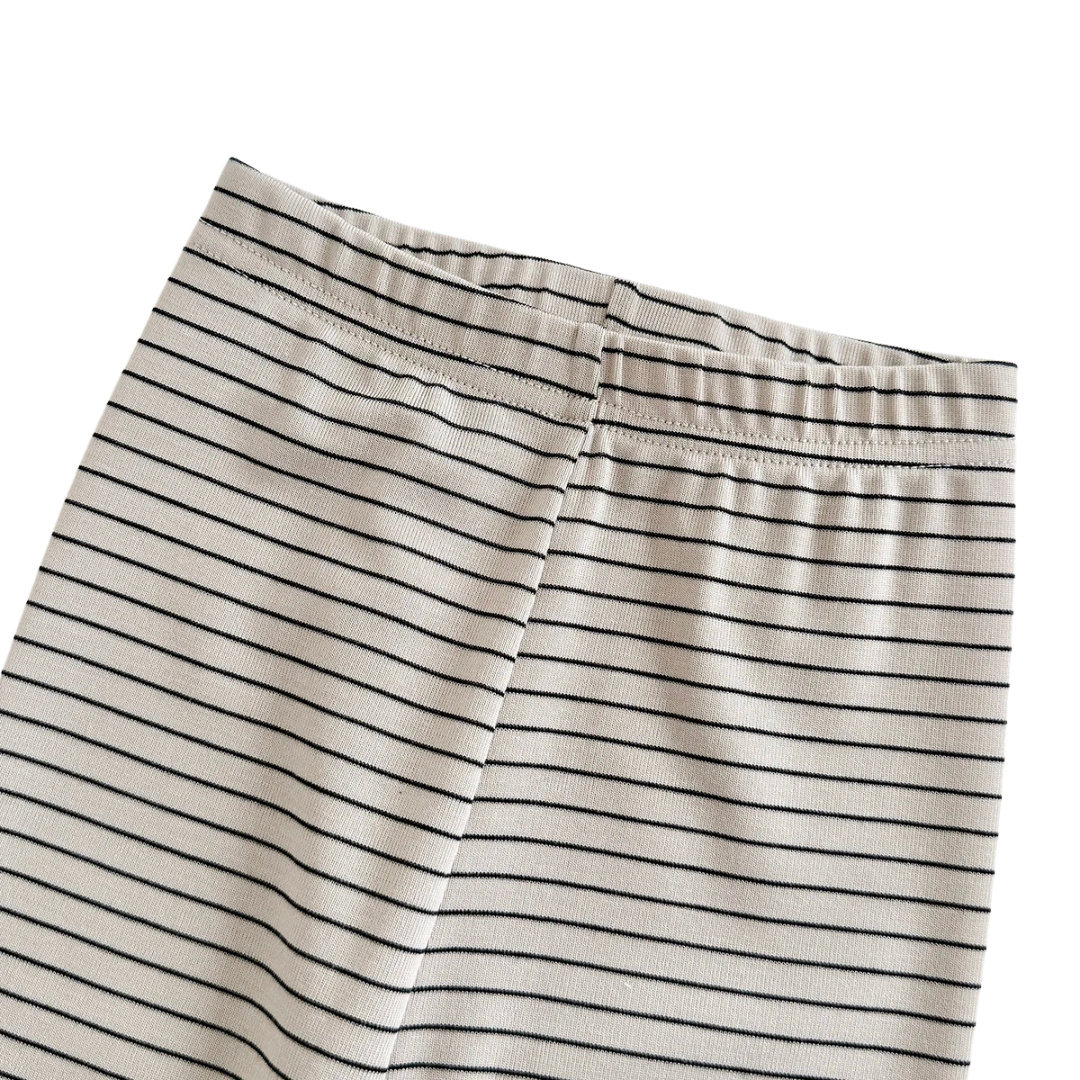 A close-up of the top elastic waistband and stitching on the striped ribbed baby leggings.