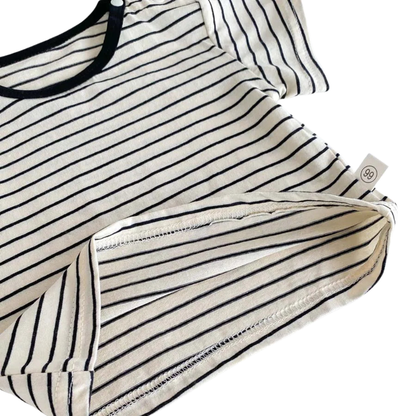 Close up of the bottom hem and soft cotton-blend fabric of the black and white striped baby boy t-shirt.