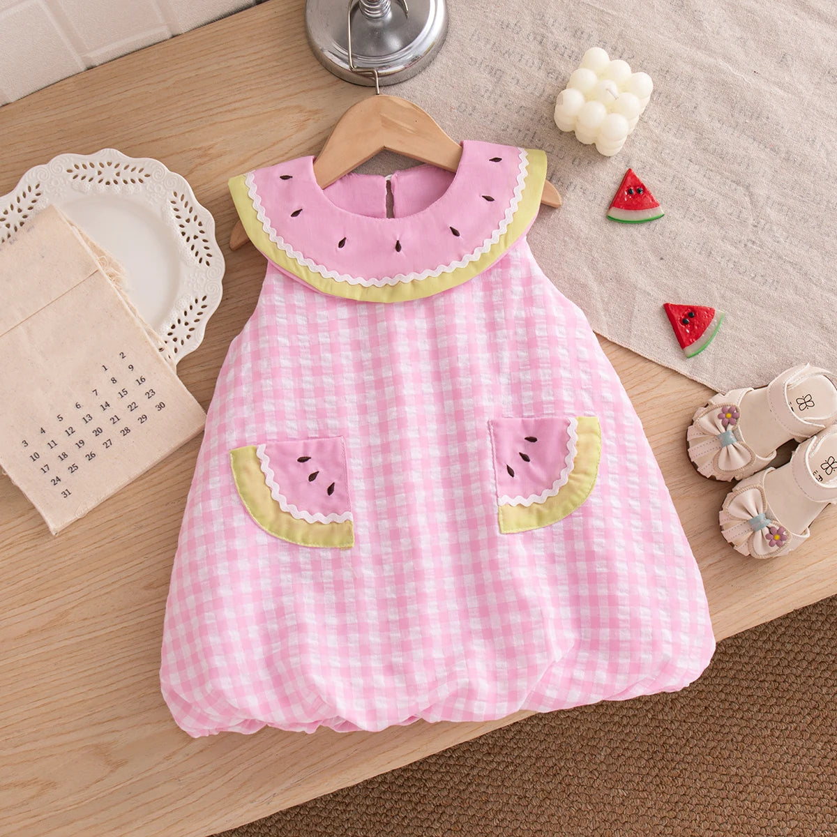 Close-up of the Summer Pink checkered bubble dress with decorative watermelon slice pockets and a matching pink statement collar.