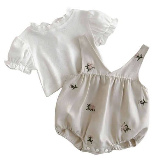 Two-piece baby girl outfit set including a short-sleeve white puff bodysuit and an embroidered beige camisole romper displayed on a white background.