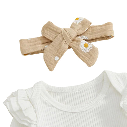 Close-up of the matching taupe daisy print baby bow headband and the ruffle shoulder detail on the white ribbed bodysuit.