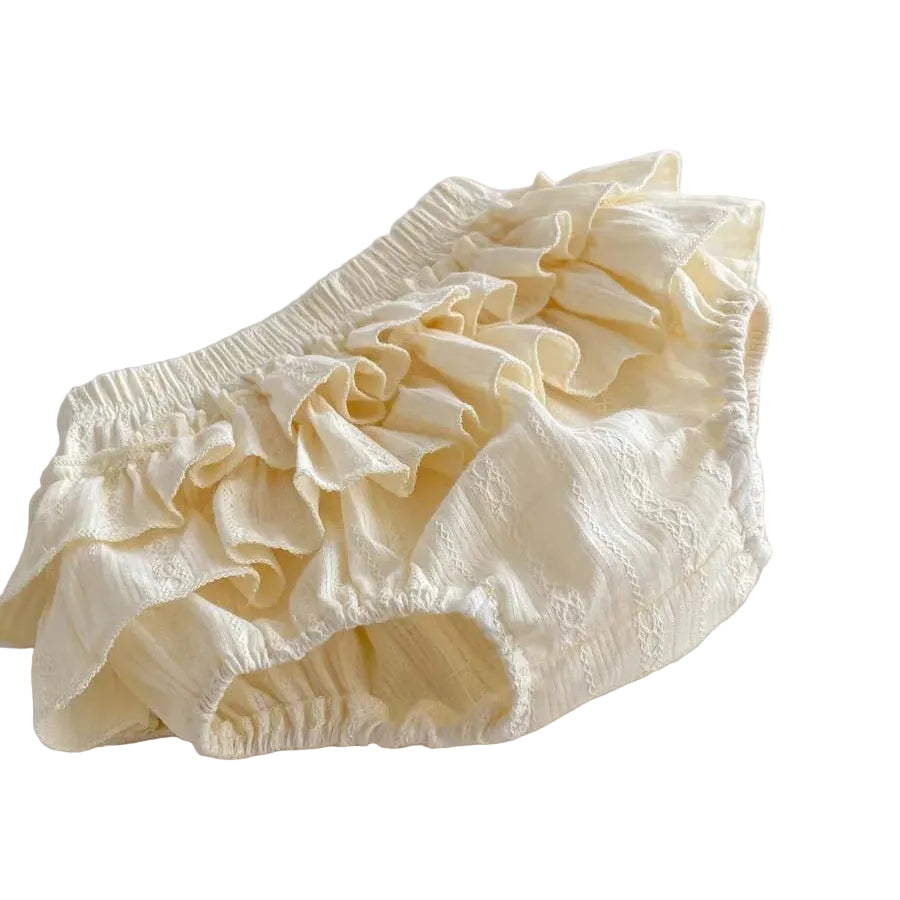 Side profile of the tiered baby girl bloomers showing the volume and "puff" silhouette of the cottagecore-inspired ruffles.