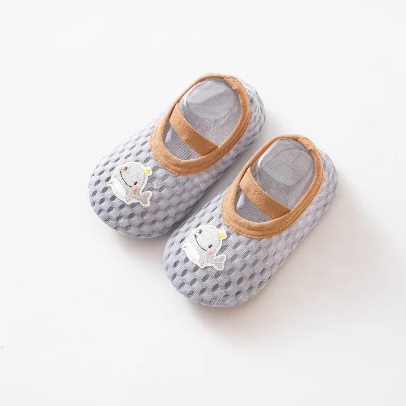 Light blue toddler aqua socks featuring a cute whale patch and non-slip rubber soles.