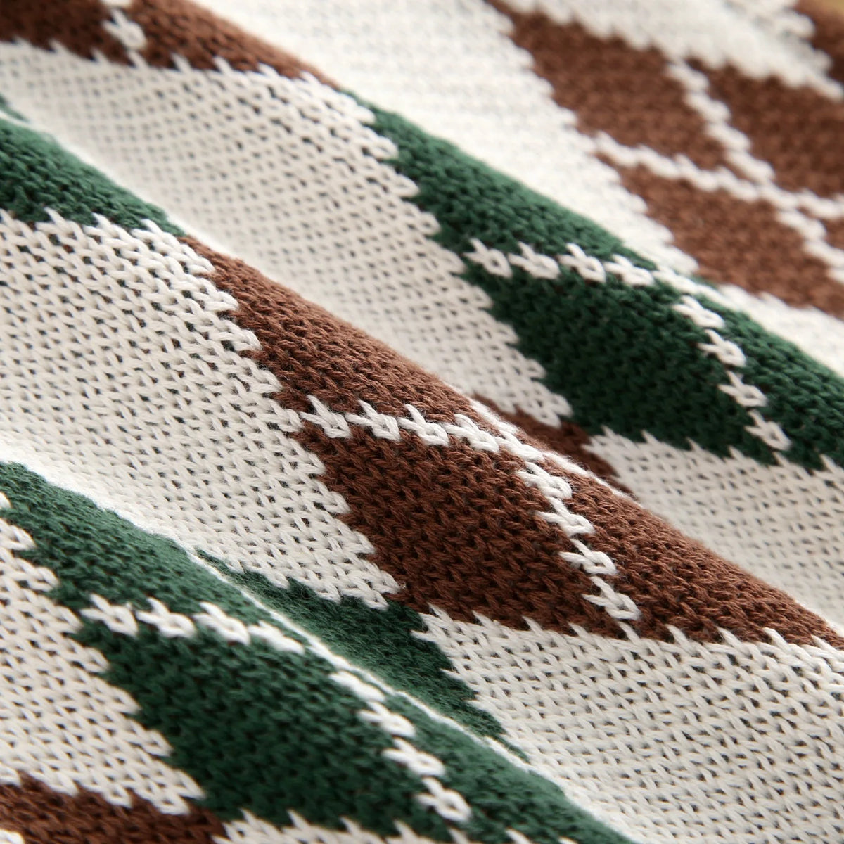 Close-up shot showing 100% cotton knit fabric texture and diamond argyle pattern detail