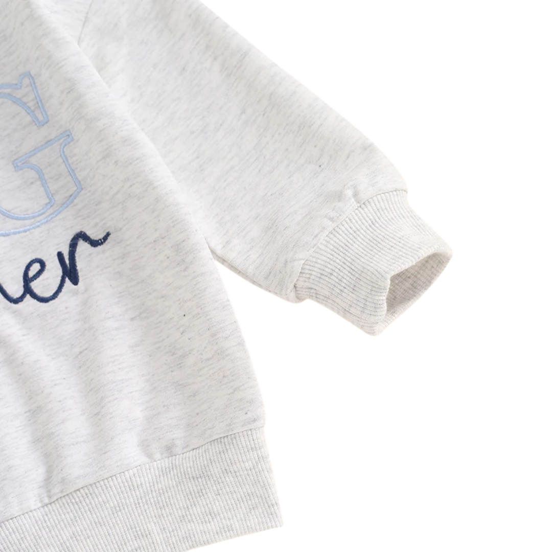 Close-up of the ribbed long sleeve cuff on the grey cotton blend toddler Big Brother sweatshirt.