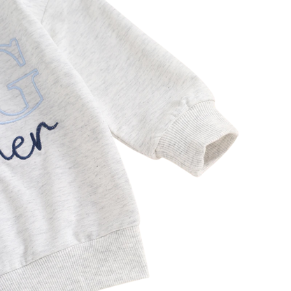 Close-up of the ribbed long sleeve cuff on the grey cotton blend toddler Big Brother sweatshirt.