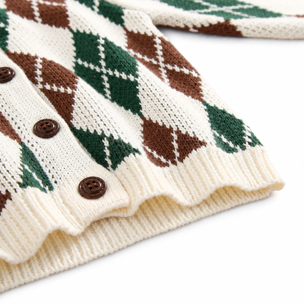 Close-up view of ribbed bottom hem and front button closure on baby boys cardigan