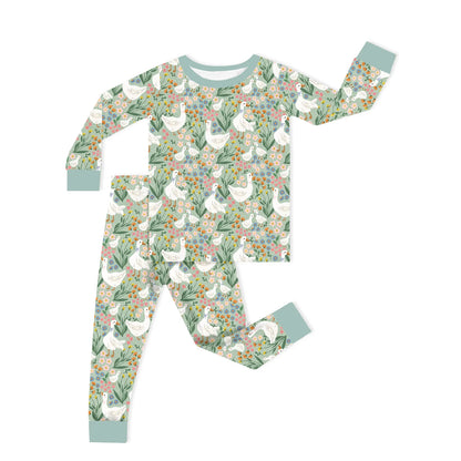 Two-piece toddler bamboo viscose pajama set flat lay with farmhouse goose and wildflower print and sage green cuffs