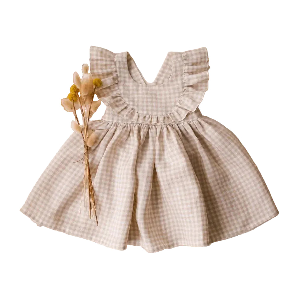 Beige and white gingham check toddler girl ruffle dress with criss-cross back straps and vintage-inspired ruffles.