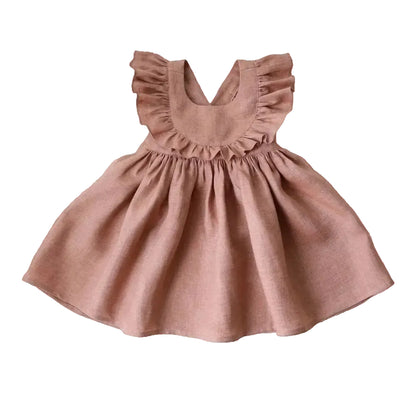 Dusty rose linen cotton ruffle sun dress for toddler girls featuring an open cross-back and gathered skirt.