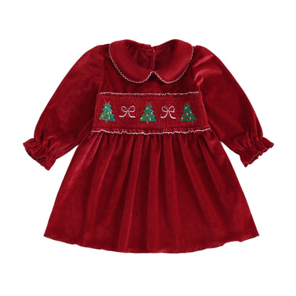 Full front view of a toddler girl red velvet smocked Christmas dress featuring long sleeves and a Peter Pan collar.
