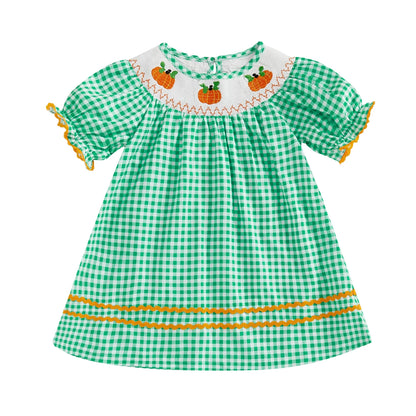 Bright green gingham smocked toddler dress with pumpkin embroidery and contrasting orange trim along the hem.