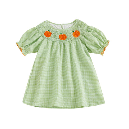 Light green gingham smocked toddler dress featuring embroidered pumpkins along the neckline.