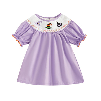 Solid lavender smocked toddler dress featuring embroidered Halloween witch hats along the neckline.