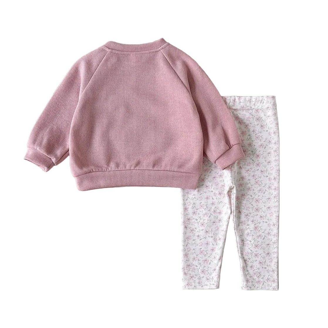 Flat lay arrangement showcasing the solid pink back view of the long-sleeve pullover sweatshirt alongside the full length of the patterned leggings.