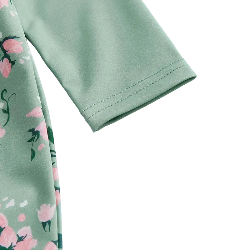 Detailed view of the long sleeve cuff and high-quality flat-lock stitching on the sage green cottagecore girl's swimwear.