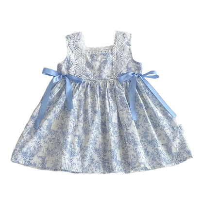 Front view of a girls blue floral toile sleeveless dress with lace bodice and satin side bows.