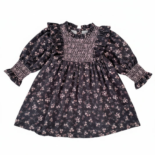 Toddler girls grey floral smocked long sleeve A-line dress with ruffle shoulders and smocked cuffs laid flat.