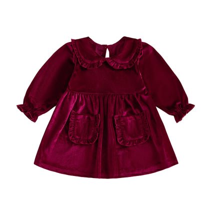 Toddler girls wine red velvet Christmas dress with Peter Pan collar and two front pockets flat lay on white background.
