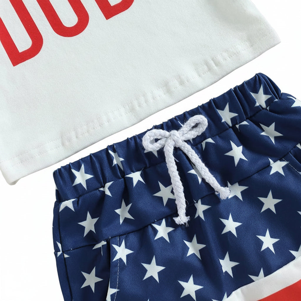 Close-up of the white graphic tee and the elastic waistband with knot-front drawstring detail on the American flag shorts.