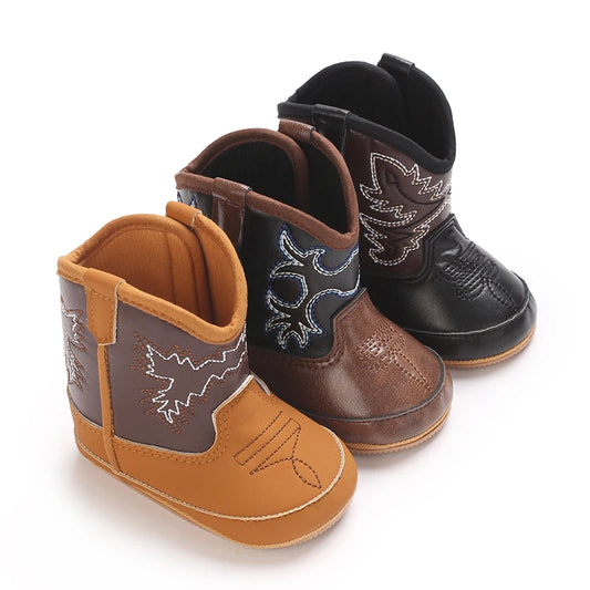 Three pairs of two-tone baby cowboy boots in tan, black, and brown western styles.