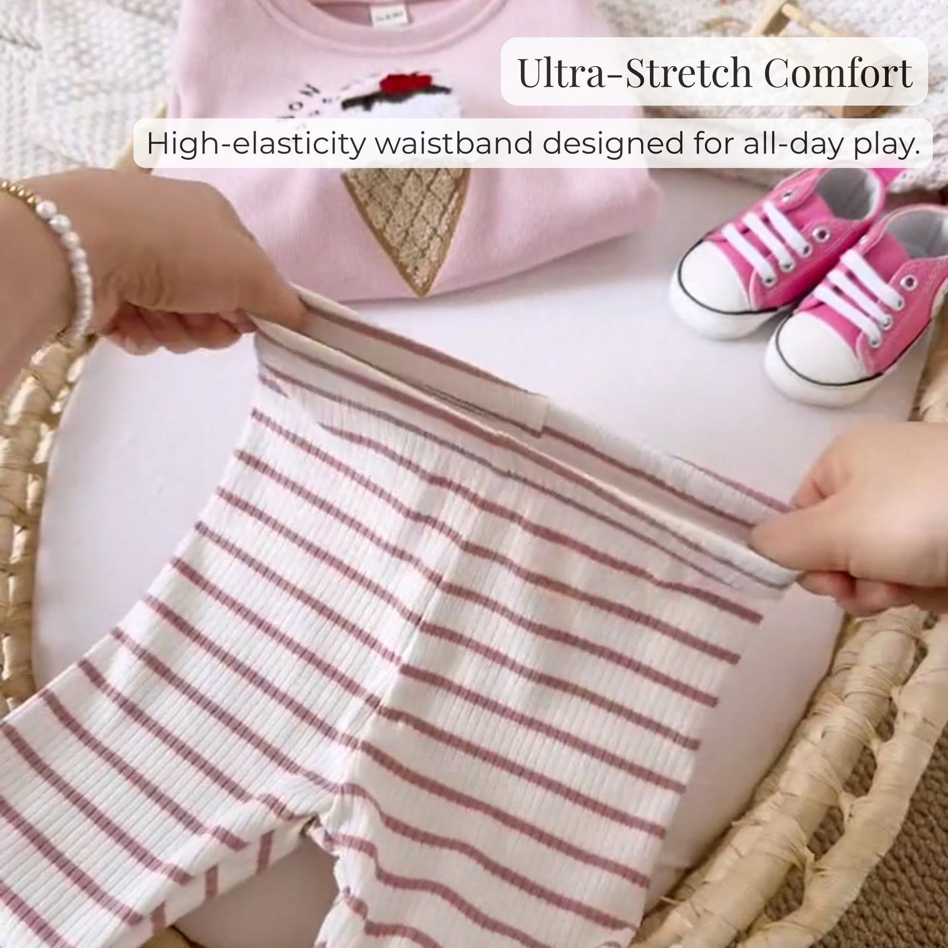Visual demonstration showcasing the flexible stretch and high-elasticity comfort of the waistband on the striped ribbed baby leggings.